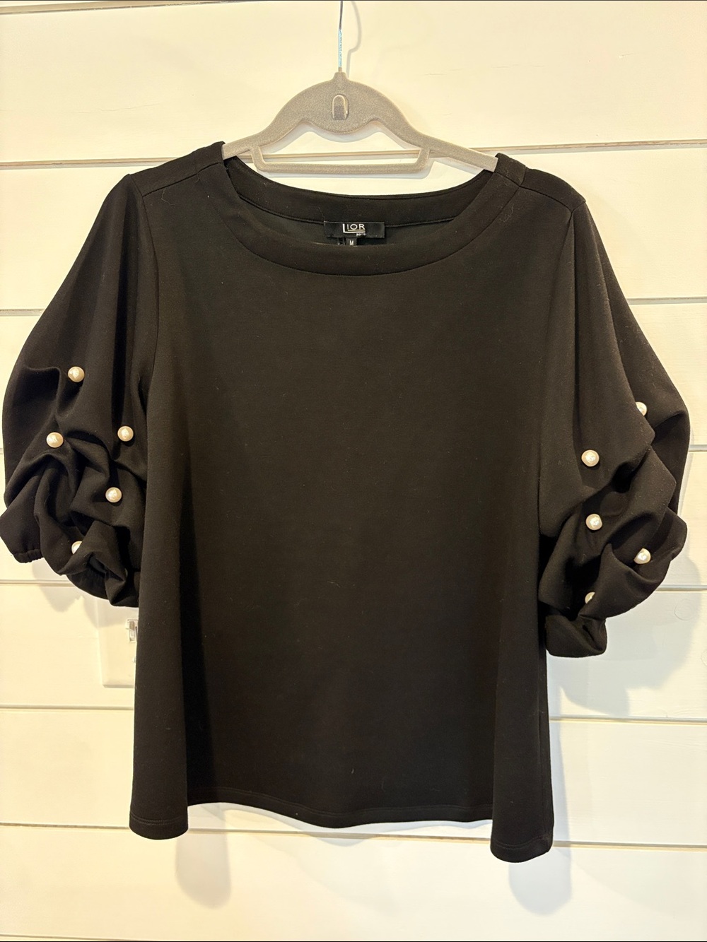 Black shirt with pear accents and blouse bunch sleeves. Lior Paris size M